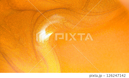 a vibrant, metallic golden-orange color with intense shimmer and swirling patterns a vibrant, metallic golden-orange color with intense shimmer and swirling patterns 126247142