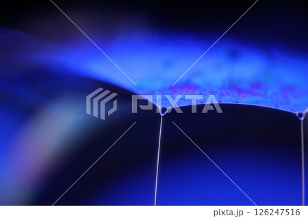 Deep purple liquid surface on black background, oil stains movement, bright chemistry, deep space background 126247516
