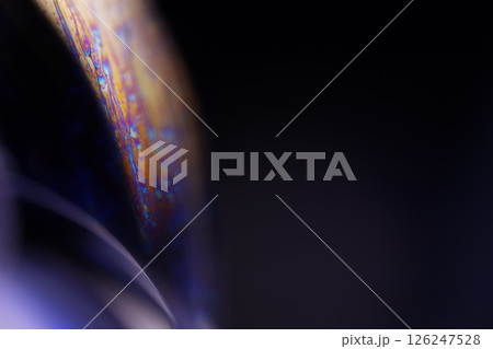 Deep purple liquid surface on black background, oil stains movement, bright chemistry, deep space background 126247528