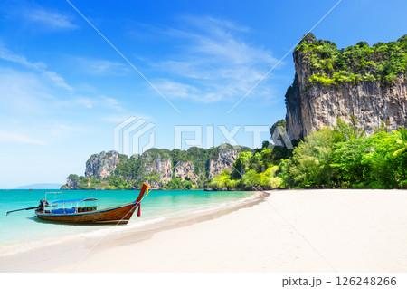 Thai traditional wooden longtail boat and beautiful white sand Railay Beach in Krabi province, Ao Nang, Thailand. Thai traditional wooden longtail boat and beautiful white sand Railay Beach in Krabi province, Ao Nang, Thailand. 126248266