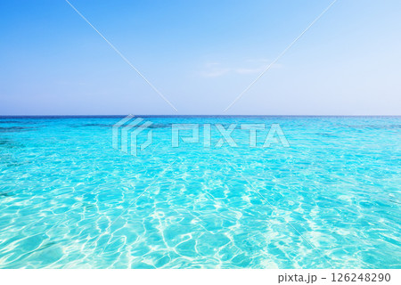 Beautiful beach with sea waves and turquoise water on a sunny day against a blue sky background in Similan Islands near Phuket, Thailand. Beautiful beach with sea waves and turquoise water on a sunny day against a blue sky background in Similan Islands near Phuket, Thailand. 126248290