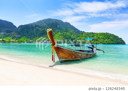 Thai traditional wooden longtail boat and beautiful sand beach in Phi Phi islands, Thailand. 126248340