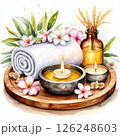 spa setting with smooth stones, lit candles, flowers, towels and bottles with aromatic oils 126248603