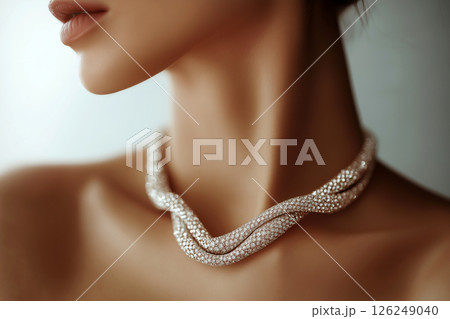 A close-up view of an elegant diamond necklace on a woman's neck, surrounded by a sophisticated atmosphere, emphasizing luxury, fashion, and exquisite jewelry at a glamorous evening setting. 126249040