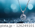 Elegant close-up of a shimmering diamond pendant in a quality gold setting, showcasing sophistication and luxury aesthetics, isolated on a dark background to emphasize its sparkle and brilliance. 126249101