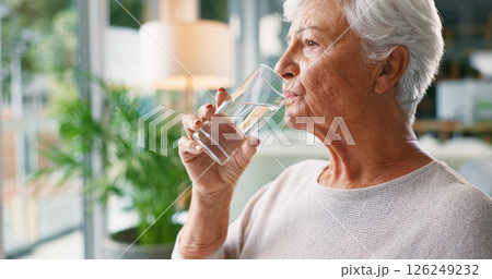 Home, drinking water and senior woman in lounge, wellness or hydration with morning routine. Nutrition, pensioner or elderly person in living room, liquid or aqua with health in retirement or thirsty Home, drinking water and senior woman in lounge, wellness or hydration with morning routine. Nutrition, pensioner or elderly person in living room, liquid or aqua with health in retirement or thirsty 126249232