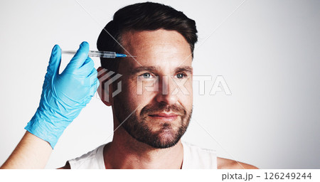 Forehead, needle and beauty with man in studio for filler injection, anti aging and aesthetic treatment. Collagen benefits, wrinkles and cosmetics with mature person and hand on white background Forehead, needle and beauty with man in studio for filler injection, anti aging and aesthetic treatment. Collagen benefits, wrinkles and cosmetics with mature person and hand on white background 126249244