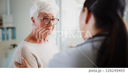 Sad woman, doctor and empathy in clinic, healthcare and consultation with support, help and talking. Pensioner, senior patient or medical with professional, results and sympathy with stress or cancer 126249403