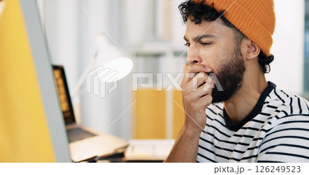 Bored, man and yawn with computer in office for exhaustion, burnout and article deadline. Male journalist, fatigue and tired with online for research, reading story and overworked for publication 126249523