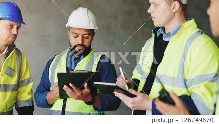Man, clipboard and group at construction site in meeting, review or planning for renovation project. Lead engineer, checklist and staff for writing, tablet or problem solving for property development 126249670