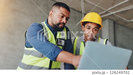 Man, laptop and architect at construction site with discussion, review and team for renovation project. Lead engineer, computer and point with partner, solution or feedback for property development 126249702