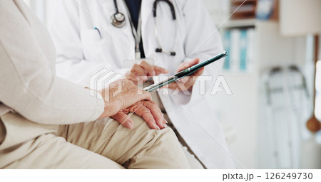 Tablet, consulting and hands of old woman and doctor for advice, discussion or cancer diagnosis. Healthcare results, digital report and medical with closeup of people in clinic for feedback on tumor 126249730