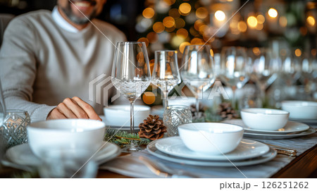 Still life served festive dinner table while Christmas lights glowing 126251262