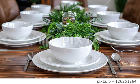 Still life served festive dinner table while Christmas lights glowing 126251264