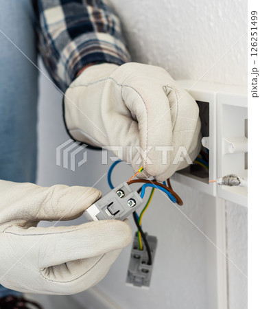Electrician at work on a residential electrical system. Electricity. 126251499