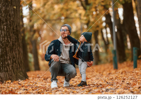 Adventure time. Father and young son is together outdoors at daytime Adventure time. Father and young son is together outdoors at daytime 126252127