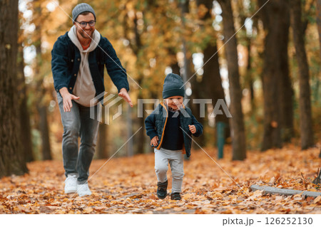 Adventure time. Father and young son is together outdoors at daytime Adventure time. Father and young son is together outdoors at daytime 126252130