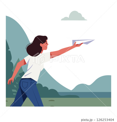 Woman throwing paper airplane outdoors near mountains and lake in nature scene 126253404