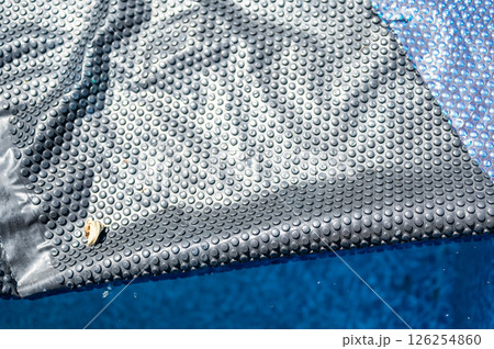 Retractable floating pool cover to keep out leaves and keep in heat being pulled back from water.  126254860