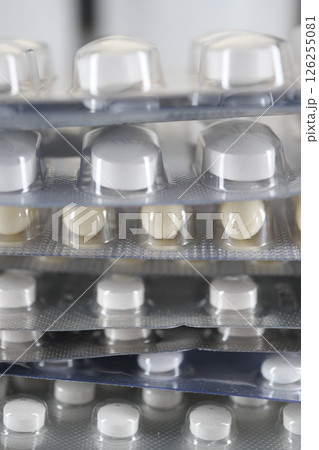 Close-up view of stacked medication blister packs on a surface Close-up view of stacked medication blister packs on a surface 126255081