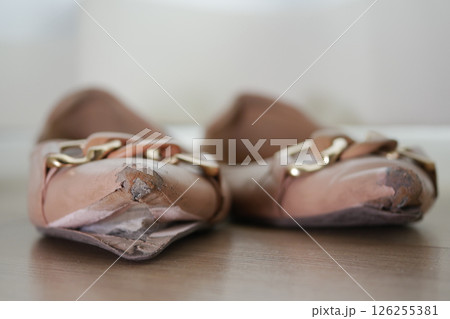 closeup of damage shoes on wooden floor closeup of damage shoes on wooden floor 126255381
