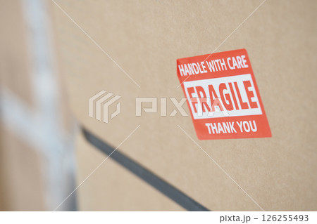 Careful handling of fragile package with warning label Careful handling of fragile package with warning label 126255493
