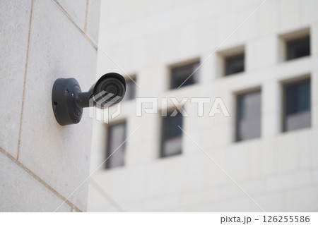 Security camera mounted on a wall at urban location during daylight 126255586