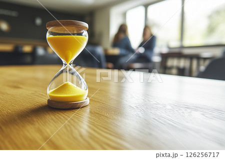 Yellow Sand Running through Hourglass Measuring Time in a Calm Modern Environment Yellow Sand Running through Hourglass Measuring Time in a Calm Modern Environment 126256717