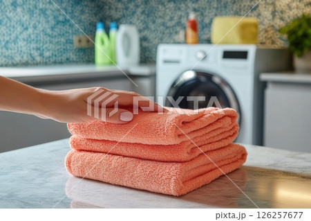 Laundry routine organizing fresh towels in a modern laundry room indoor still life clean and cozy close-up home management Laundry routine organizing fresh towels in a modern laundry room indoor still life clean and cozy close-up home management 126257677