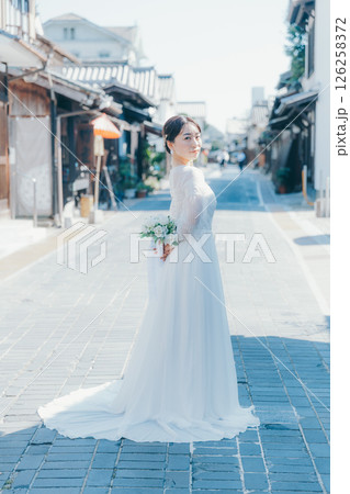 伝統的な町並みに立つウェディングドレス姿の女性のポートレート 126258372