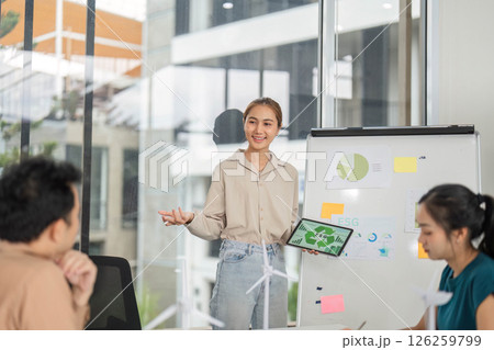 ESG Presentation in Business Meeting. Young woman explaining sustainability concepts to colleagues. 126259799