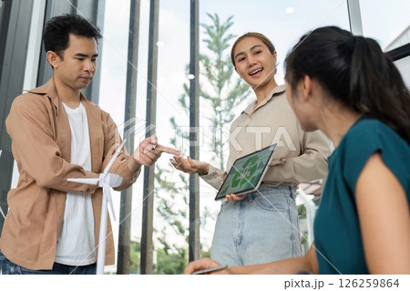 ESG and Sustainability. Team discussing eco-friendly business strategies in modern office. 126259864