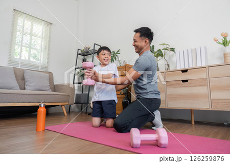 Family bonding during fitness activities with father and son 126259876