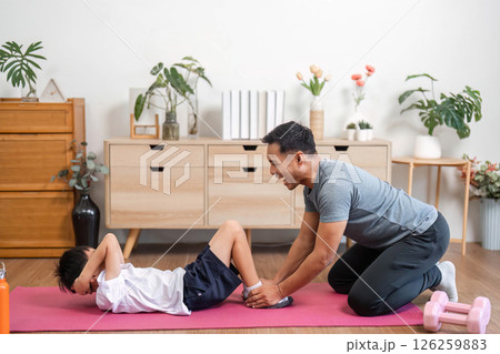 Family workout joy with father and son having fun at home 126259883