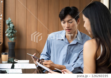 Business Collaboration. Young professionals analyzing data together in a stylish office. Business Collaboration. Young professionals analyzing data together in a stylish office. 126260195