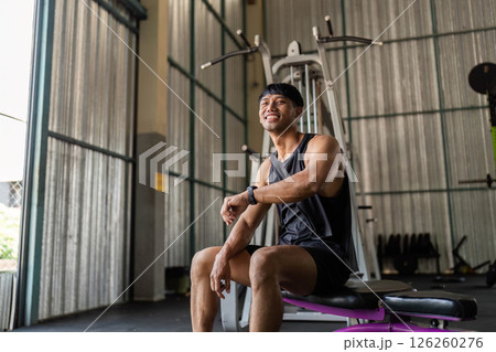 Fitness: Smiling After Workout in Gym moment to rest, reflecting on his workout Fitness: Smiling After Workout in Gym moment to rest, reflecting on his workout 126260276