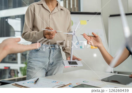 Sustainable Business Practices. Professionals collaborating on ESG strategies with renewable energy models. Sustainable Business Practices. Professionals collaborating on ESG strategies with renewable energy models. 126260439