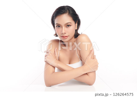 A beautiful young Asian woman with clean, fresh skin against a white background. Skincare, facial treatment, cosmetology, beauty, and spa. An elegant portrait of an Asian woman. 126264575