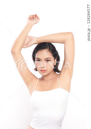 Beautiful Young Asian woman Raises her hands to Showcase clean and hygienic underarms Against a white background, Smooth armpit cleanliness and protection concept 126264577
