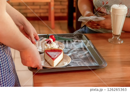 Ordering desert at a cafe at a meeting of friends during a lunch break to discuss important 126265363