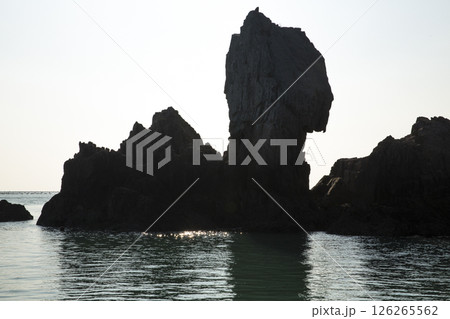 A small rocky island with oddly shaped rocks in the middle of the sea A small rocky island with oddly shaped rocks in the middle of the sea 126265562