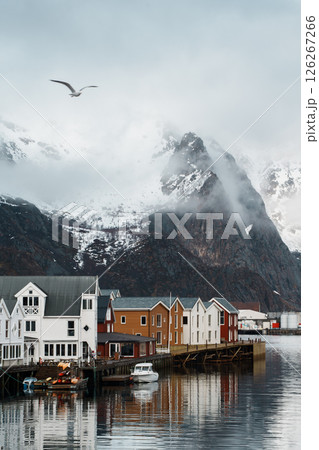 Fishing village of Henningsvaer with snowy mountain backdrop Fishing village of Henningsvaer with snowy mountain backdrop 126267266