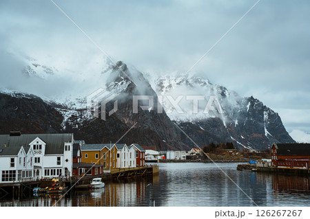 Fishing village of Henningsvaer with snowy mountain backdrop Fishing village of Henningsvaer with snowy mountain backdrop 126267267