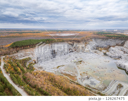 Stone quarry in the forest. Flying over the autumn mixed forest during sunset. The surroundings of Yekaterinburg. Ural, Russia, Aerial View 126267475