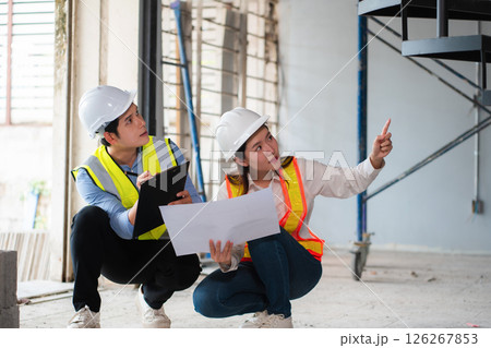 Construction engineers discussion with architects at construction site or building site 126267853