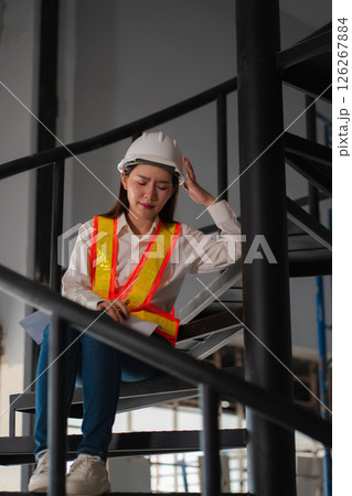 Concept of business failure and unemployment problem, unemployment stress Engineer sitting on stairs. Concept of business failure and unemployment problem, unemployment stress Engineer sitting on stairs. 126267884