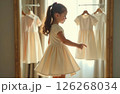 Little girl spinning trying on dress in store 126268034