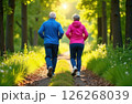Gray-haired grandparents in tracksuits jogging in the park, view from the back 126268039