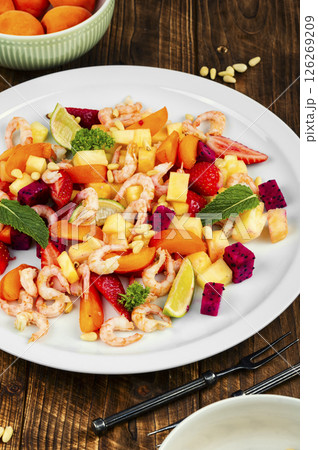 Salad with tropical fruits and shrimps. 126269209