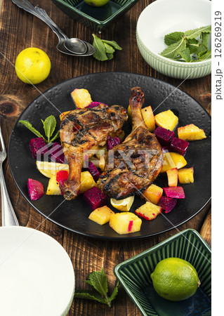 Duck legs marinated in pineapple and slices dragon fruit. Duck legs marinated in pineapple and slices dragon fruit. 126269219